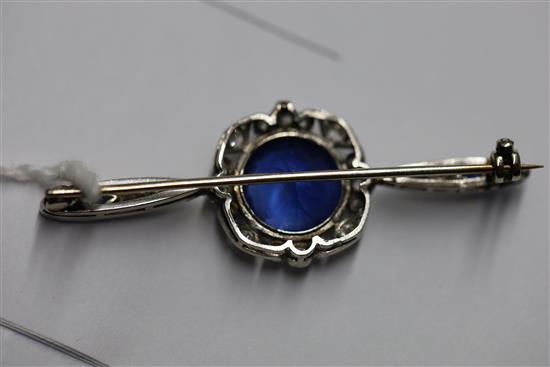 A sapphire and diamond bar brooch, the central round-cut sapphire with diamond border, flanked by marquise-set diamonds and sapphires